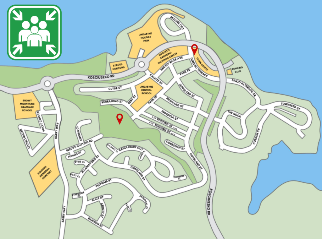 Two red pins mark locations on a coastal town map with roads, roundabout, and blue water to the east.